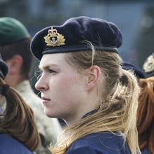 Close-up side-view of a female Royal Navy officer in beret