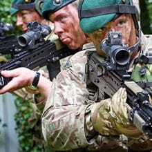 Three Royal Marines with guns on training exercise