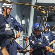 RFA sailors pulling on lines during replenishment at sea operation