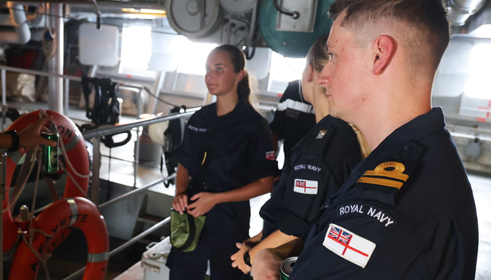 group of blue uniformed in engine room onboard vessel