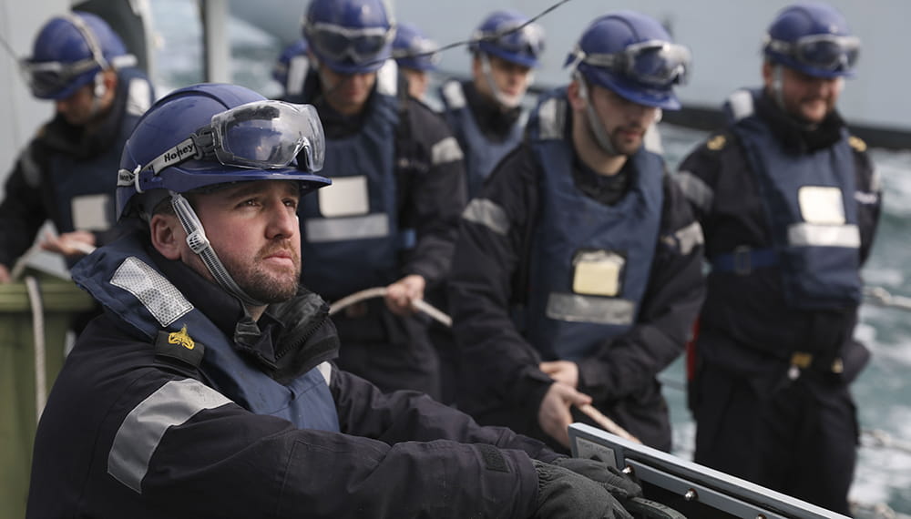 Royal Navy sailors on the deck wearing blue helmets