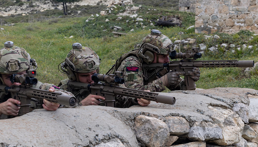 Royal Marines in a line wearing equipment and holding weapons. Photograph of day one of the new advert shoot in Cyprus.