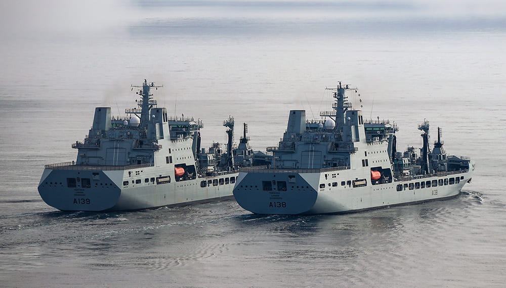 Photo of two large boats at sea. The Tide class tankers were conducting replenishment at sea trials (RAS).