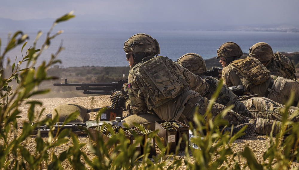Royal marines train with the army in Cyprus. Marines from 45 Commando fire support group with the general purpose machine gun.