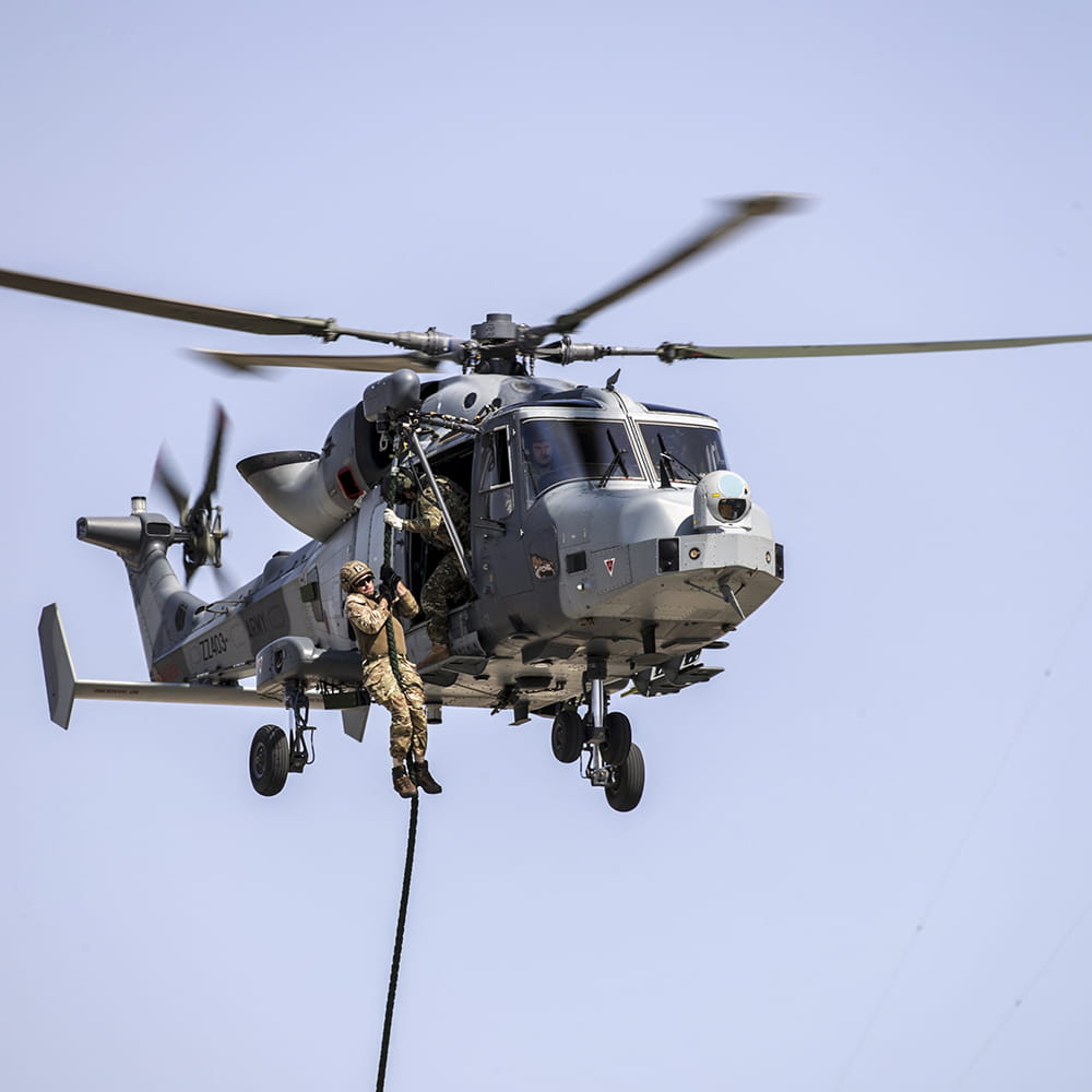 Royal Marine 42 Commando abseiling from a Wildcat