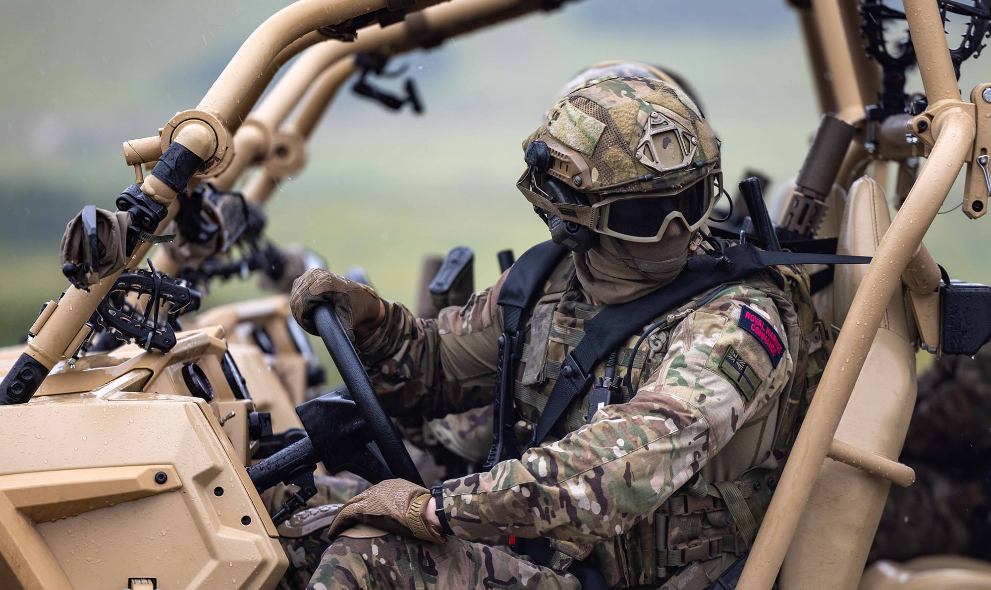 Royal Marine with face covered sat in a Polaris MRZR-D4