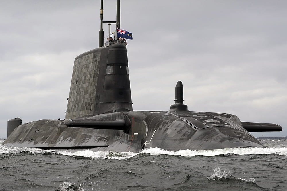 Astute Class submarine emerges from the grey sea in Scotland