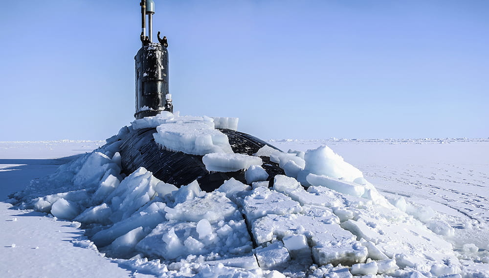 Royal Navy submarine, HMS Trenchant breaks through the frozen Arctic sea ice