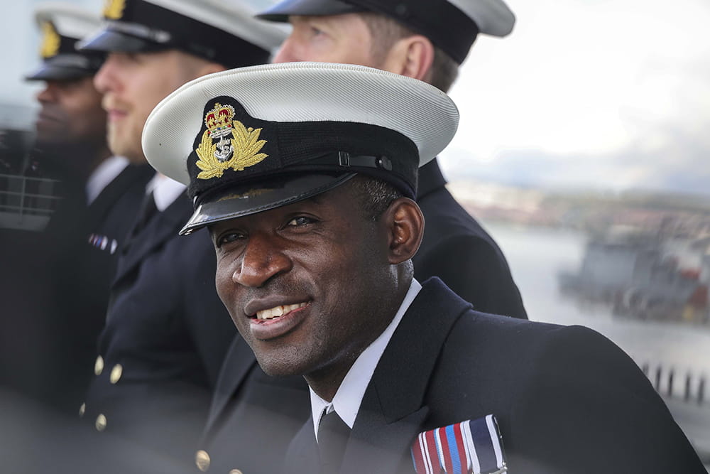 A Royal Navy officer peers to see his loved ones