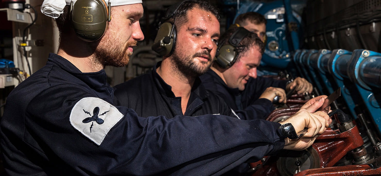 Electrical Technician (Marine Engineering) (ET(ME)) McCardle, ET(ME) Hobson, Leading ET(ME) Eady and Lietuenat Prior in the forward engine room.