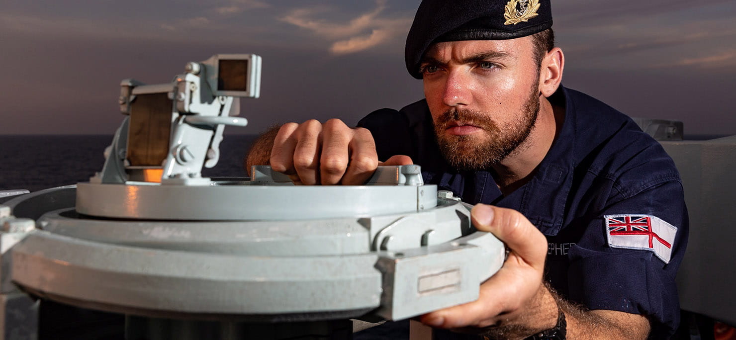Pictured is SLt Cameron Shepherd of HMS Albion using the pelorus to take a bearing of vessels at sea in the Far East.