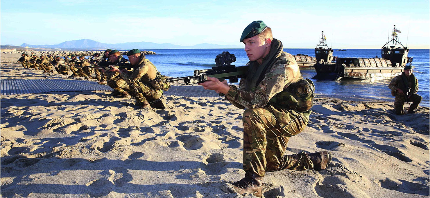 Royal Marines and sailors from the UK’s Flagship HMS Bulwark and RFA Lyme Bay secure a beachhead whilst practicing their amphibious skills during Exercise Sea Snake