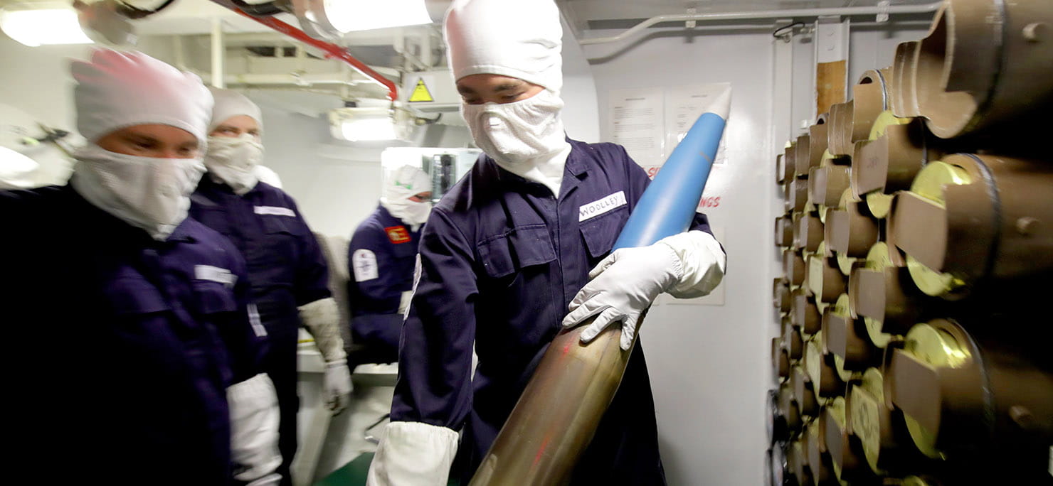 HMS Lancaster's Weapon Engineers holding artillery shells