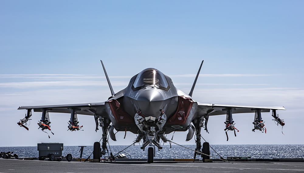F-35 Lightning jet on the deck of aircraft carrier pointing straight towards the camera