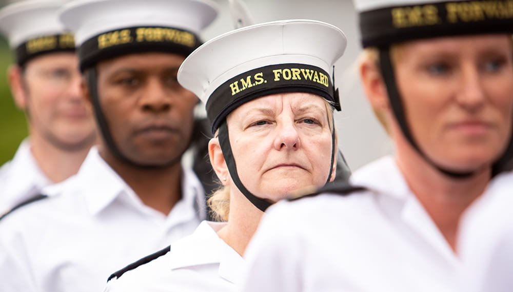 Four Royal Navy sailors wearing white uniform 