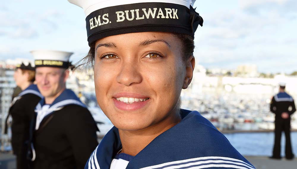 Female Royal Navy sailor smiles at camera